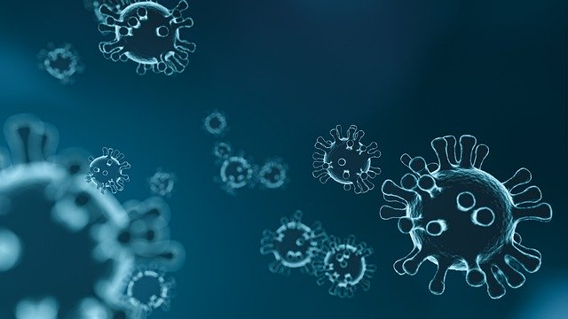 Digital illustration of virus particles floating against a dark blue background